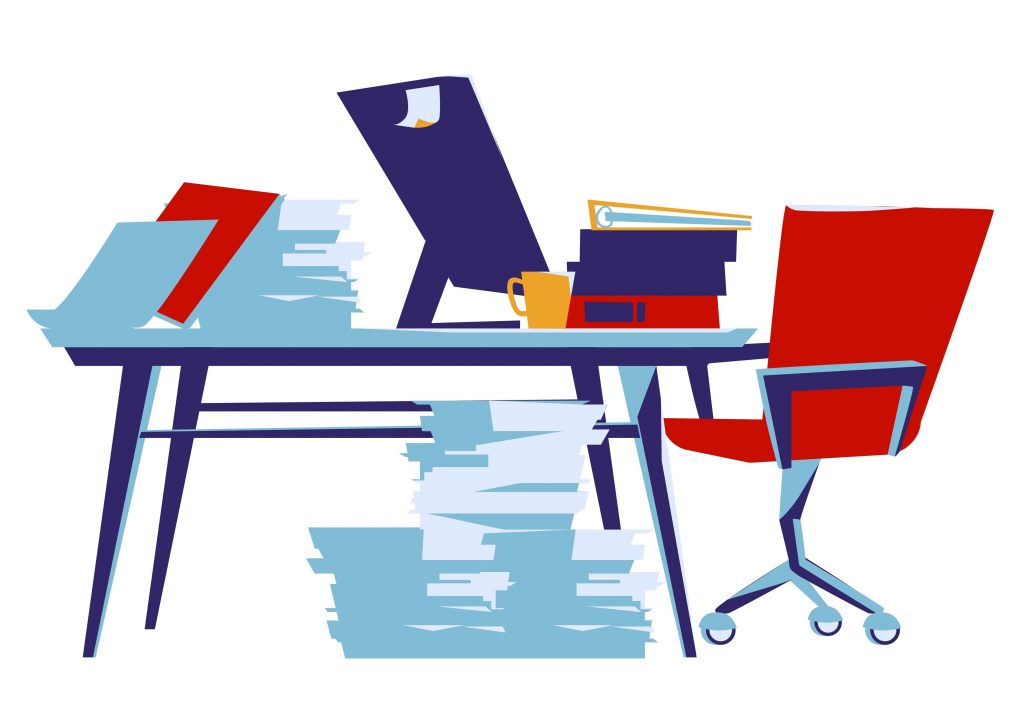 Office desk with lots of paperwork and folders.